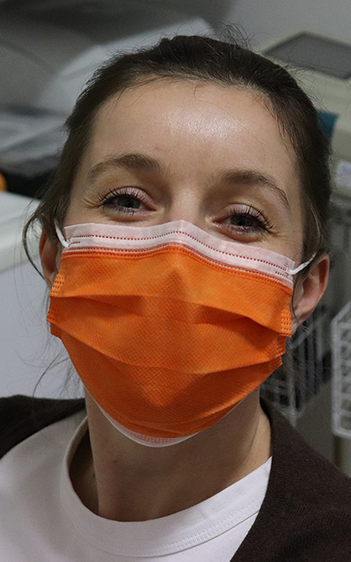 female nurse with an orange mask on