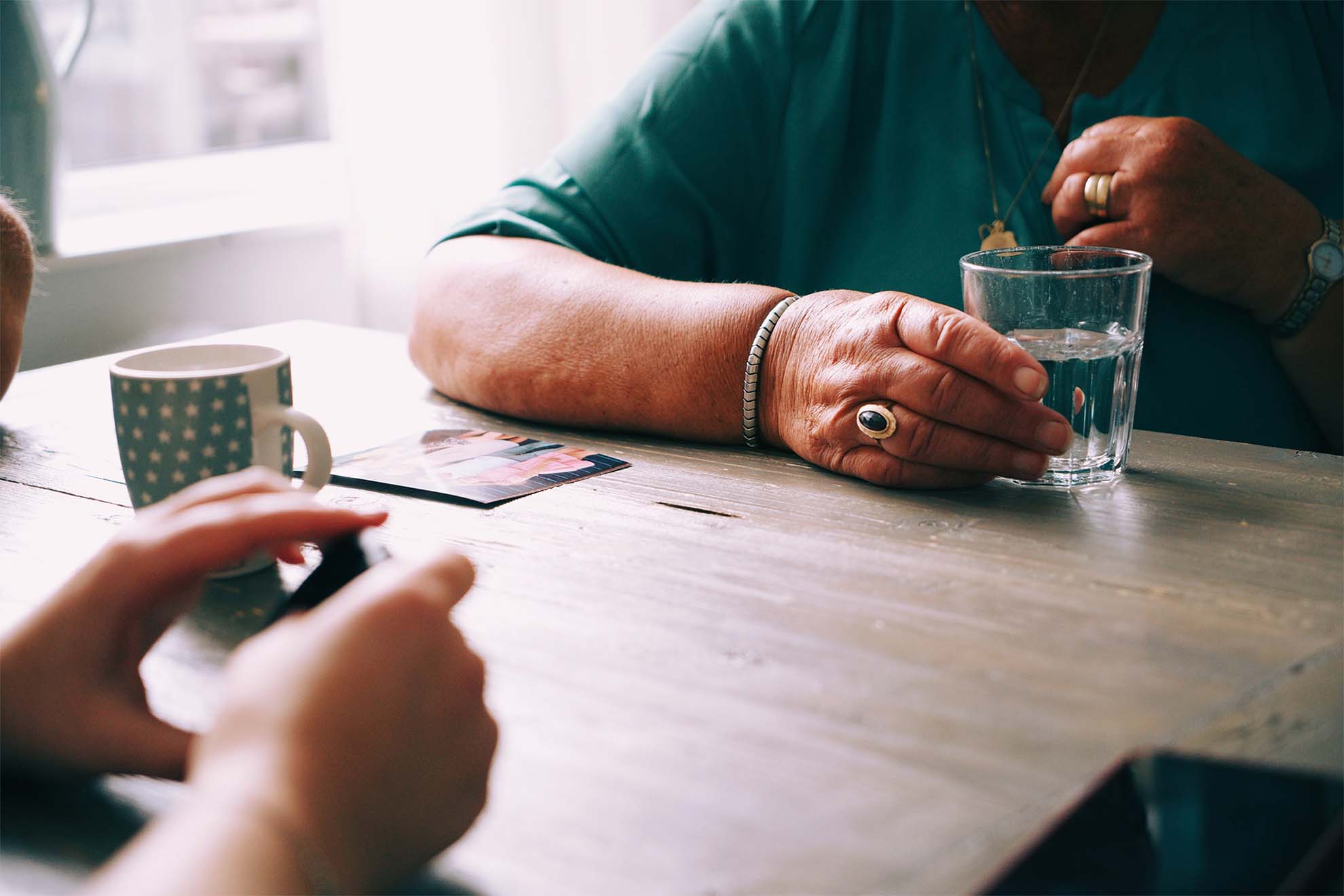 two residents playing a game together whilst having a drink